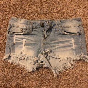 Blue shorts with frayed bottoms